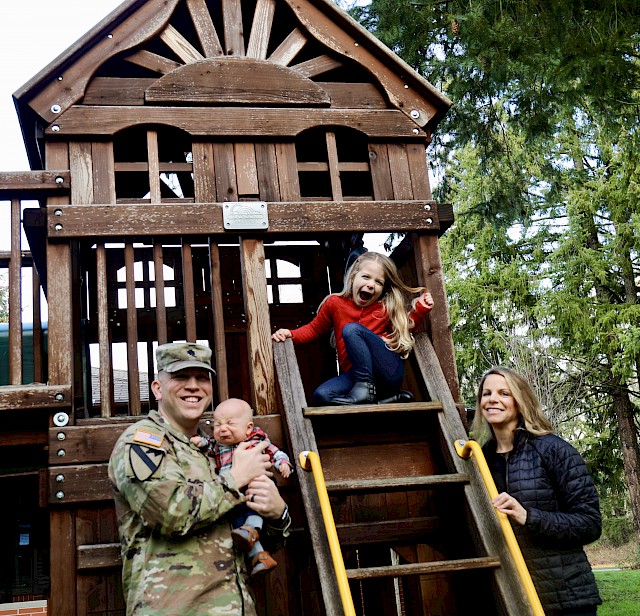 Army Lt. Col. John Miller and his family pose outside the Joint Base Lewis-McChord Army Fisher House in Washington.